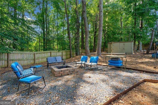 view of patio / terrace featuring a storage unit and an outdoor fire pit