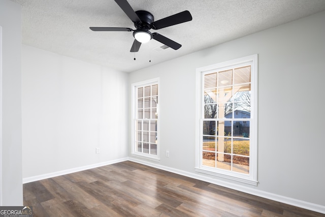 unfurnished room featuring dark hardwood / wood-style floors, a textured ceiling, and ceiling fan