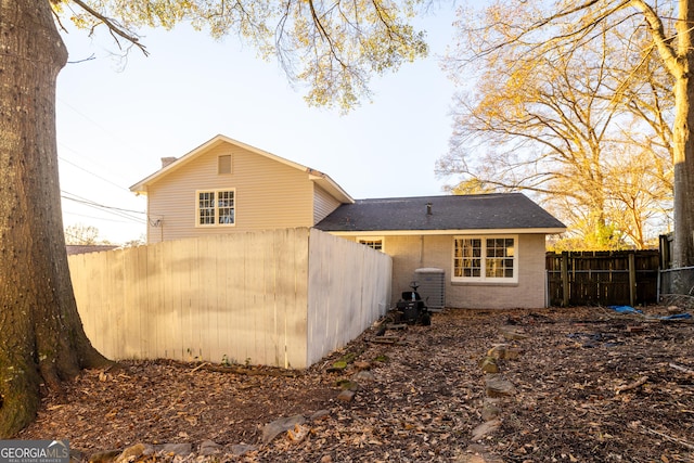 rear view of property featuring central AC