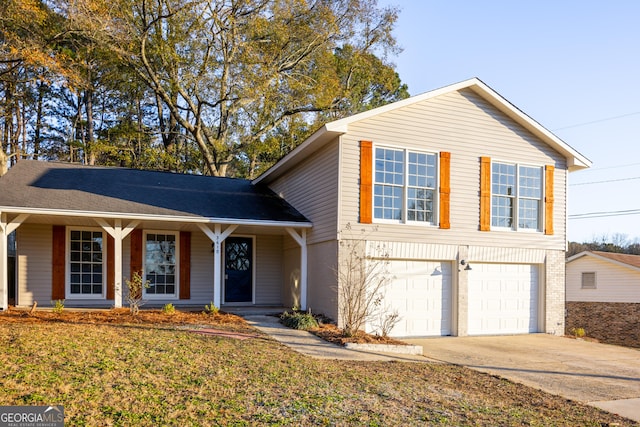 view of front of property with a garage and a front lawn