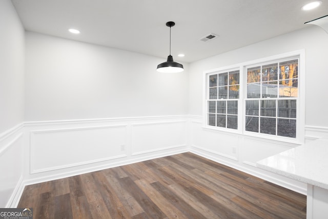 unfurnished dining area with dark hardwood / wood-style flooring