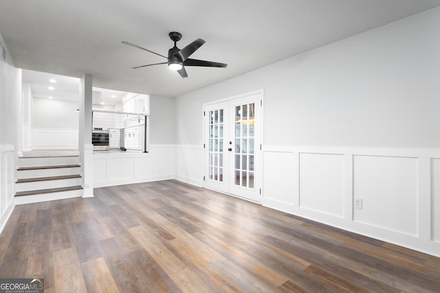 unfurnished living room with ceiling fan, dark hardwood / wood-style flooring, and french doors