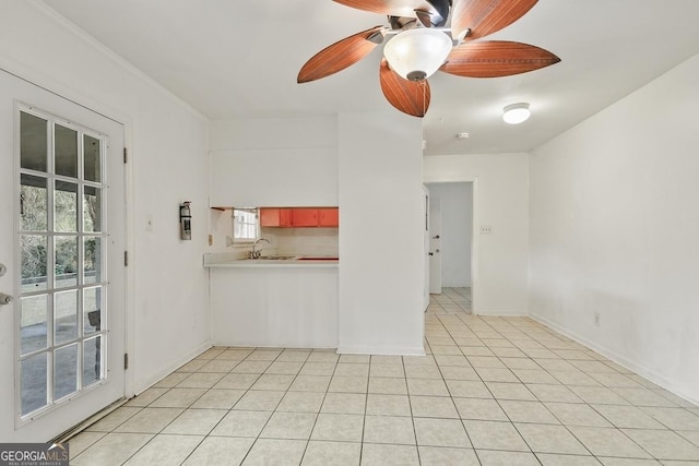 unfurnished living room featuring light tile patterned floors and sink