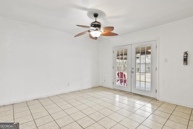 empty room featuring ceiling fan, light tile patterned flooring, and french doors