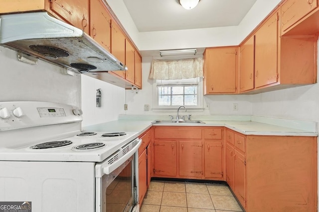 kitchen with light tile patterned floors, electric range, and sink