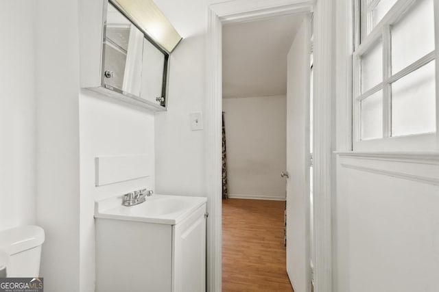 bathroom featuring hardwood / wood-style floors, vanity, and toilet