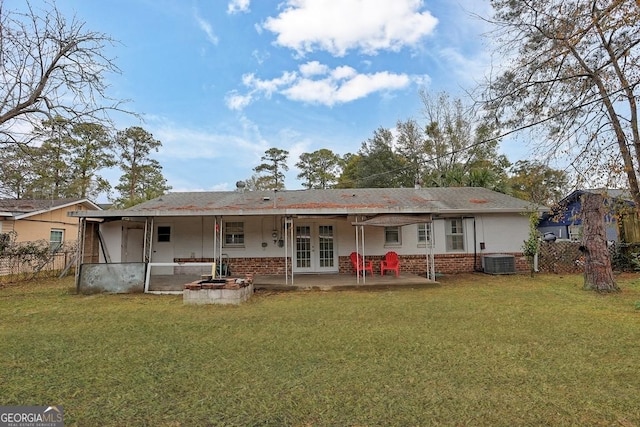 rear view of house featuring french doors, a yard, and central AC