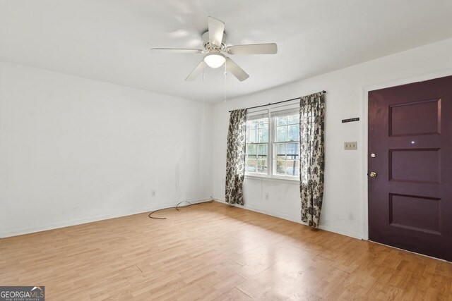 foyer with ceiling fan and light hardwood / wood-style floors