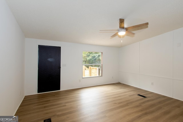 spare room featuring ceiling fan and hardwood / wood-style floors