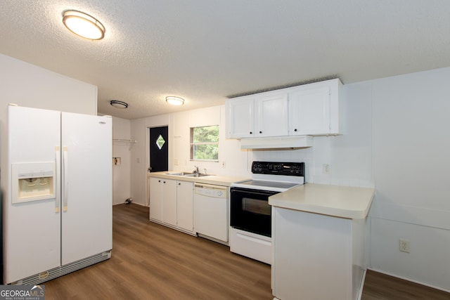 kitchen featuring dark hardwood / wood-style flooring, white appliances, a textured ceiling, sink, and white cabinets