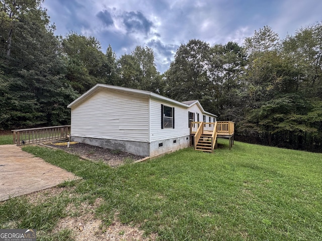 view of home's exterior with a lawn and a deck