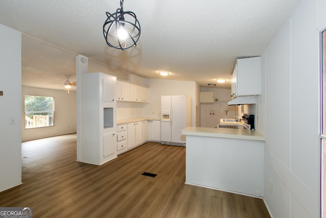 kitchen with pendant lighting, stove, white refrigerator with ice dispenser, dark hardwood / wood-style floors, and white cabinetry