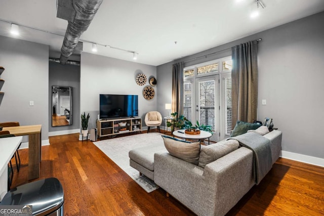 living room with wood-type flooring and track lighting