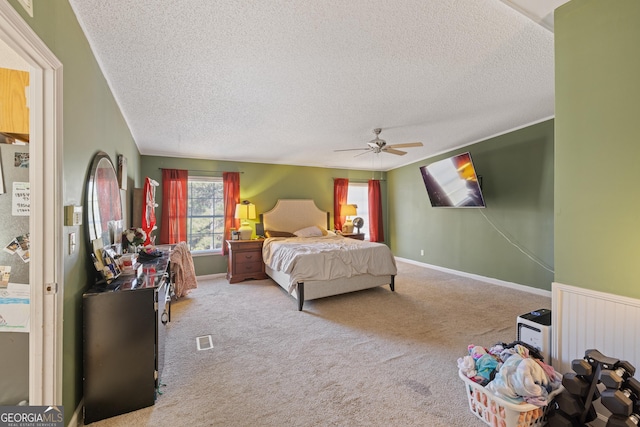 bedroom with carpet flooring, radiator heating unit, a textured ceiling, and ceiling fan