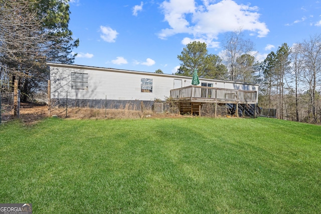 back of house with a yard and a wooden deck