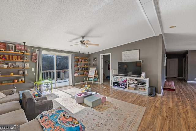 living room with a textured ceiling, ceiling fan, lofted ceiling, and hardwood / wood-style flooring