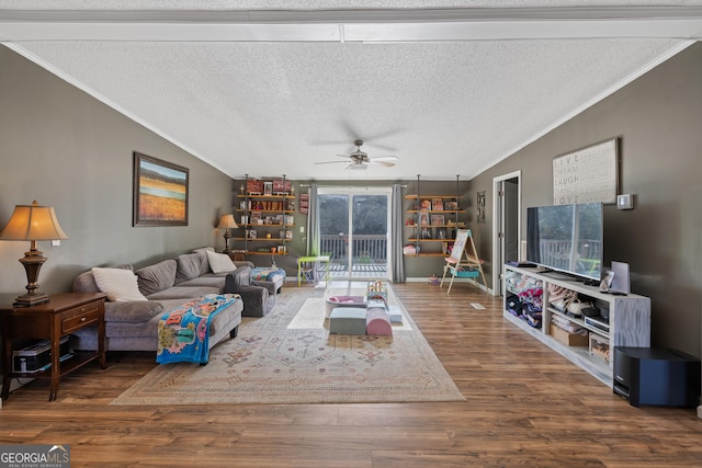 living room featuring wood-type flooring, a textured ceiling, ceiling fan, and crown molding