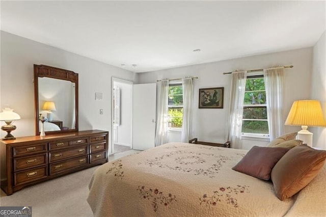 carpeted bedroom featuring multiple windows