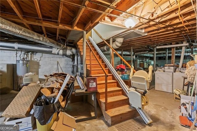 basement featuring water heater and washing machine and dryer