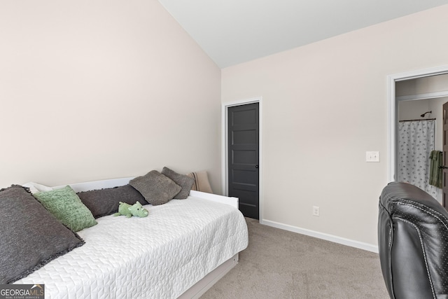 bedroom with light colored carpet and lofted ceiling