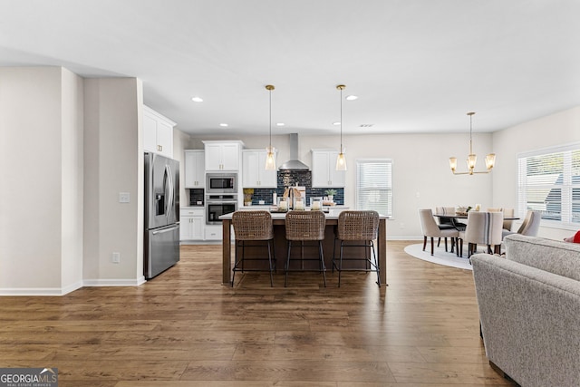 dining room featuring sink, dark wood-type flooring, a chandelier, and plenty of natural light