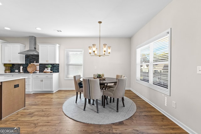 dining room featuring an inviting chandelier and light hardwood / wood-style floors