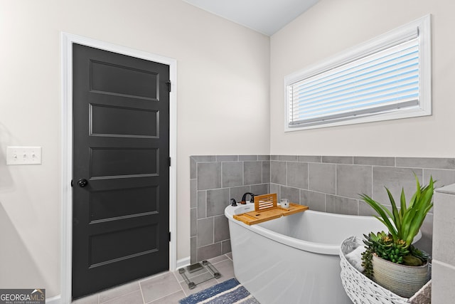 bathroom featuring tile patterned floors and a bath