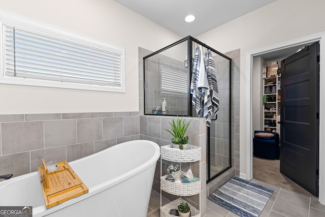 bathroom with tile patterned floors and separate shower and tub