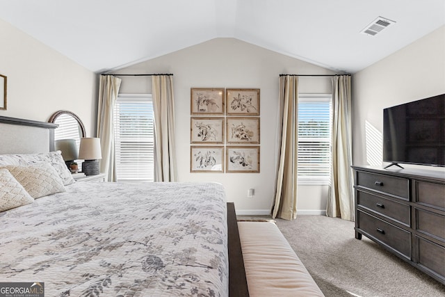 bedroom with multiple windows, vaulted ceiling, and carpet