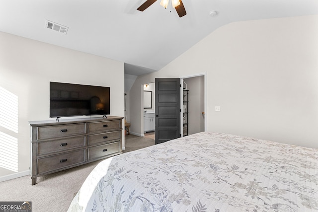 carpeted bedroom featuring lofted ceiling, ensuite bathroom, and ceiling fan