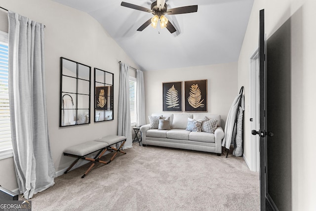 living room with light colored carpet, ceiling fan, and vaulted ceiling