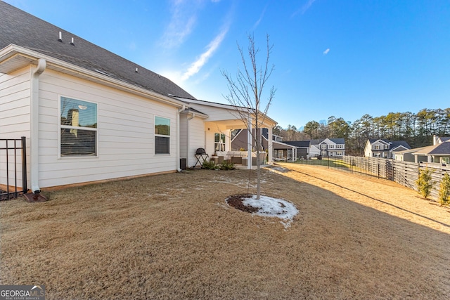 back of property featuring a yard