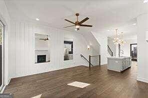 unfurnished living room featuring dark hardwood / wood-style floors and a notable chandelier