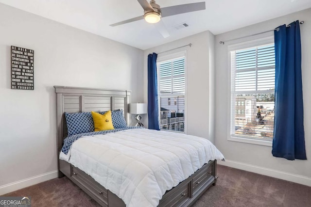 bedroom featuring ceiling fan and dark colored carpet