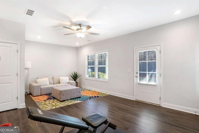 interior space with ceiling fan and dark wood-type flooring