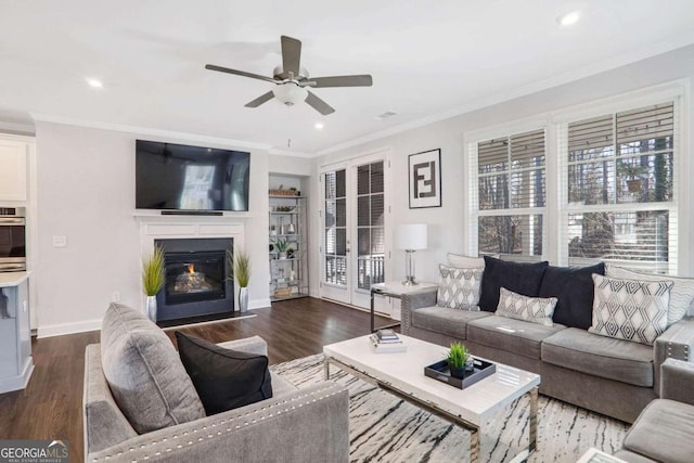 living room with ceiling fan, dark hardwood / wood-style flooring, and ornamental molding