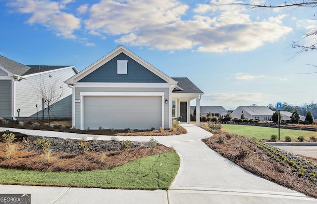 view of front facade featuring a front yard and a garage