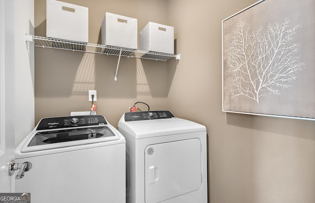 laundry room with washing machine and clothes dryer