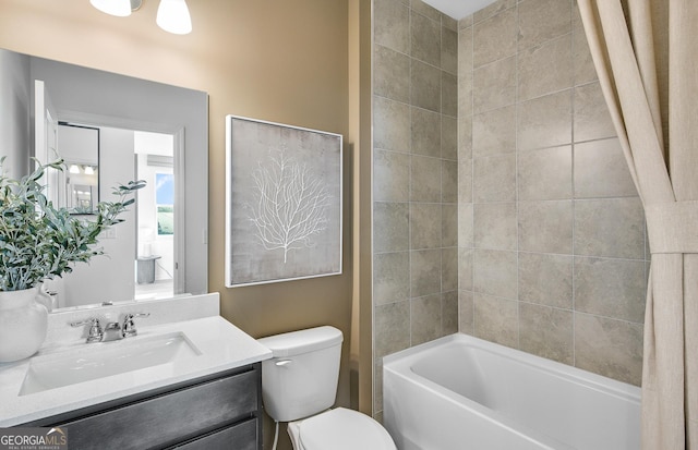 full bathroom featuring vanity, bathtub / shower combination, and toilet