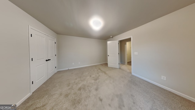 unfurnished bedroom with light colored carpet