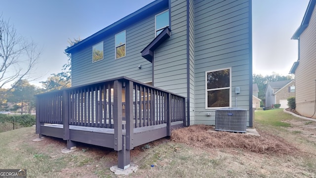 rear view of property featuring central AC and a deck