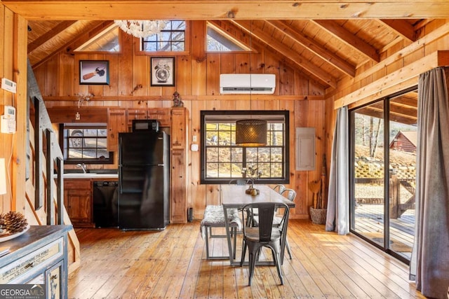 dining space featuring beam ceiling, light wood-type flooring, wood walls, and a wall unit AC