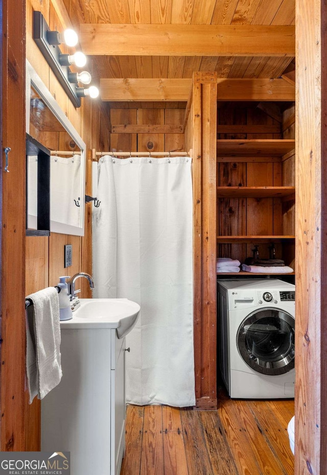 clothes washing area with washer / clothes dryer, wooden walls, hardwood / wood-style floors, and wood ceiling