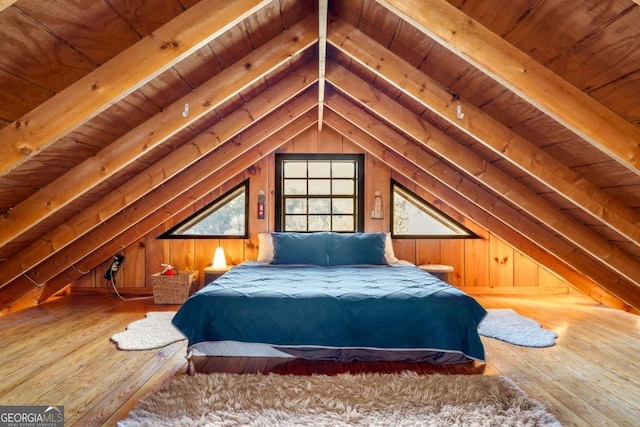 bedroom featuring wooden ceiling, wooden walls, and hardwood / wood-style flooring