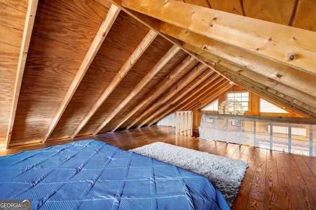 unfurnished bedroom with hardwood / wood-style flooring, lofted ceiling, and wood ceiling