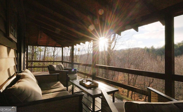 wooden terrace with an outdoor hangout area