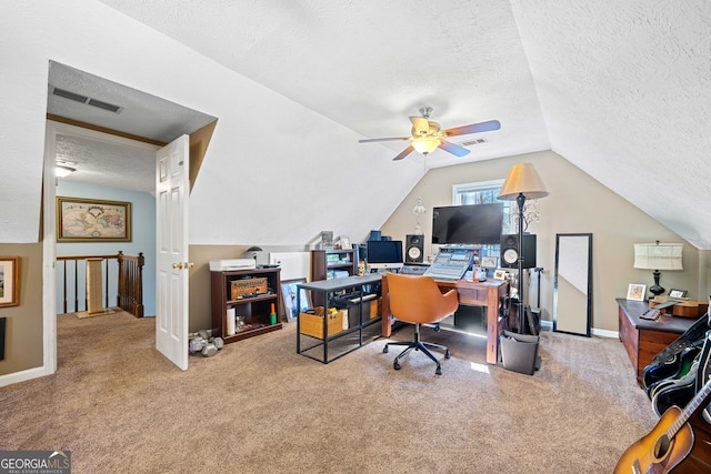 office area featuring lofted ceiling, ceiling fan, carpet floors, and a textured ceiling