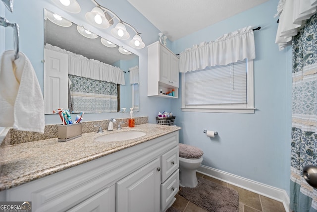 bathroom featuring tile patterned floors, vanity, and toilet