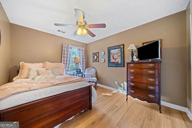 bedroom with light wood-type flooring and ceiling fan