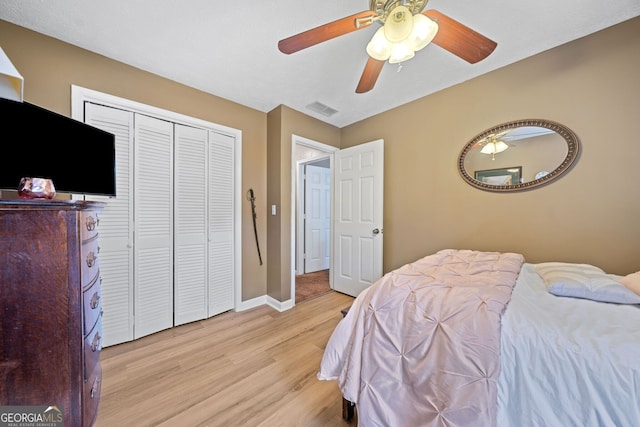 bedroom with ceiling fan, a closet, and light hardwood / wood-style flooring